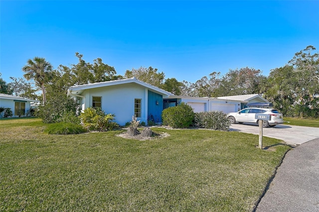 ranch-style house with a garage and a front lawn