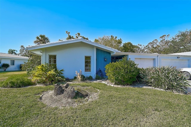 single story home featuring a garage and a front yard