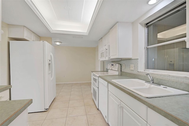 kitchen featuring sink, light tile patterned flooring, white appliances, a tray ceiling, and white cabinets