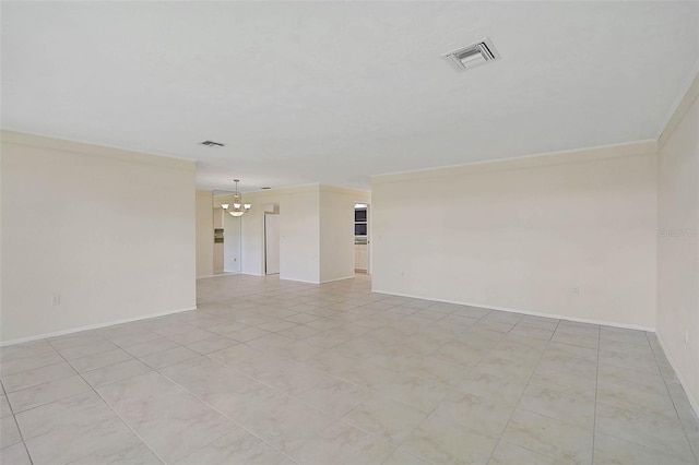 empty room with crown molding, light tile patterned floors, and a chandelier