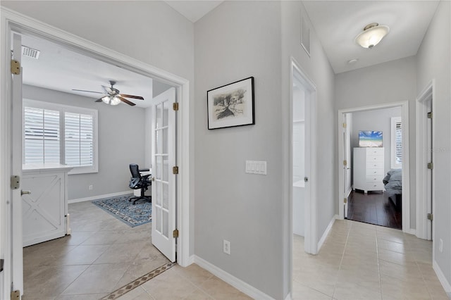 hall with light tile patterned flooring