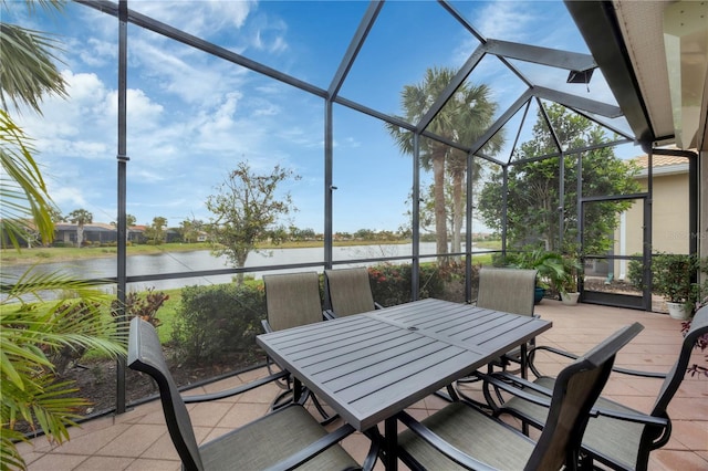 view of patio / terrace featuring glass enclosure and a water view