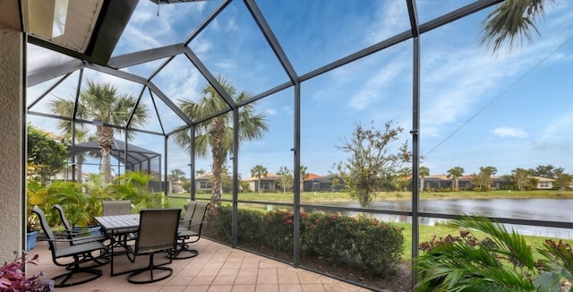 unfurnished sunroom featuring a water view