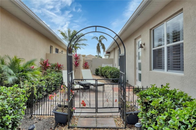 view of gate with a patio