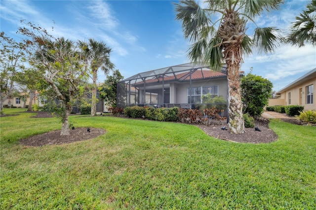 view of front of property with a front lawn and glass enclosure