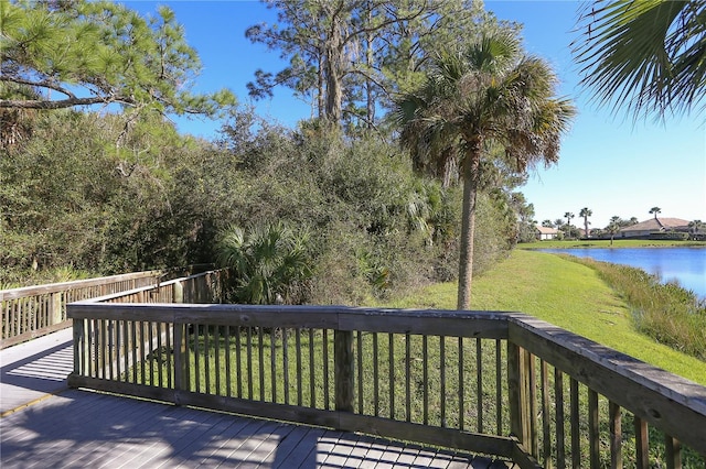 deck with a lawn and a water view