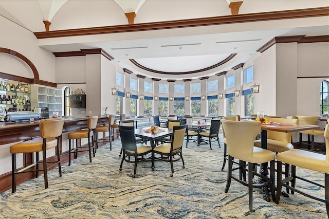 dining space featuring a towering ceiling