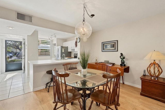 dining area featuring light hardwood / wood-style flooring and sink