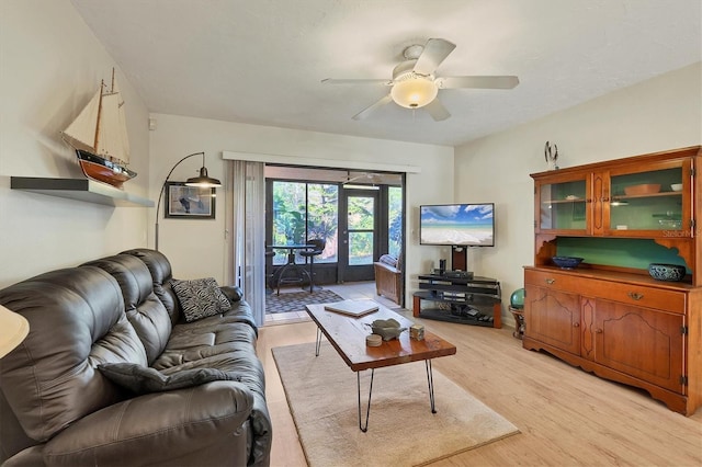 living room with ceiling fan, french doors, and light hardwood / wood-style flooring