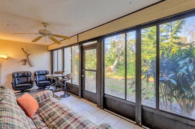 sunroom / solarium featuring ceiling fan