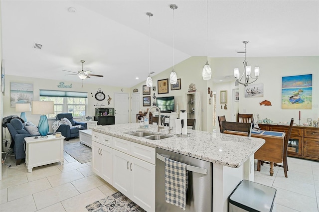 kitchen featuring pendant lighting, dishwasher, lofted ceiling, sink, and an island with sink