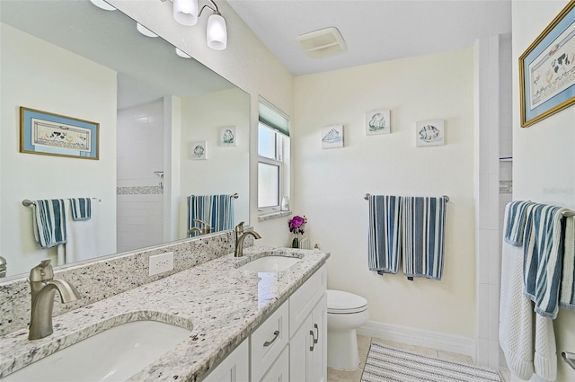 bathroom featuring tile patterned flooring, vanity, toilet, and walk in shower