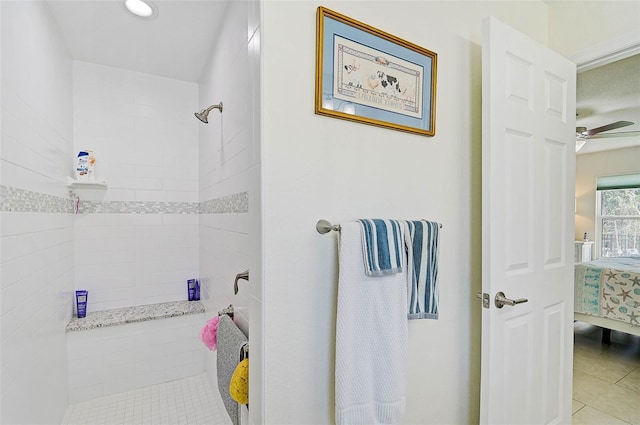 bathroom with tiled shower, tile patterned flooring, and ceiling fan