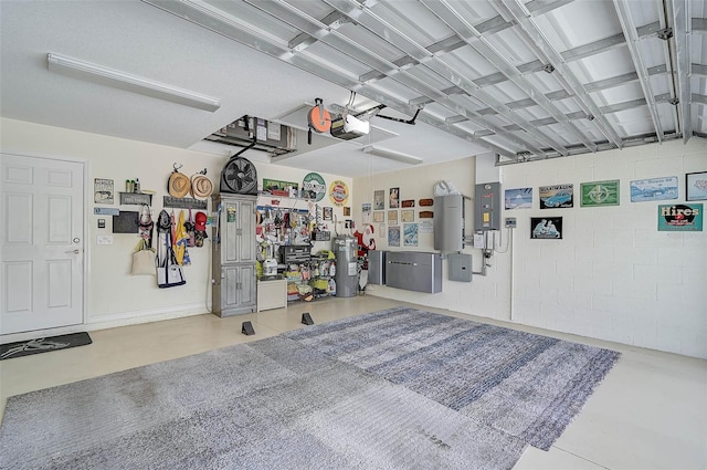 garage with a garage door opener and water heater