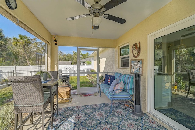 sunroom featuring ceiling fan