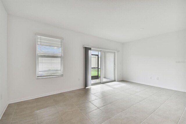 unfurnished room with light tile patterned flooring