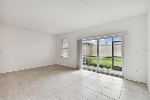 spare room featuring light tile patterned floors