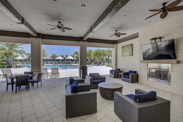 view of patio / terrace with an outdoor living space with a fireplace