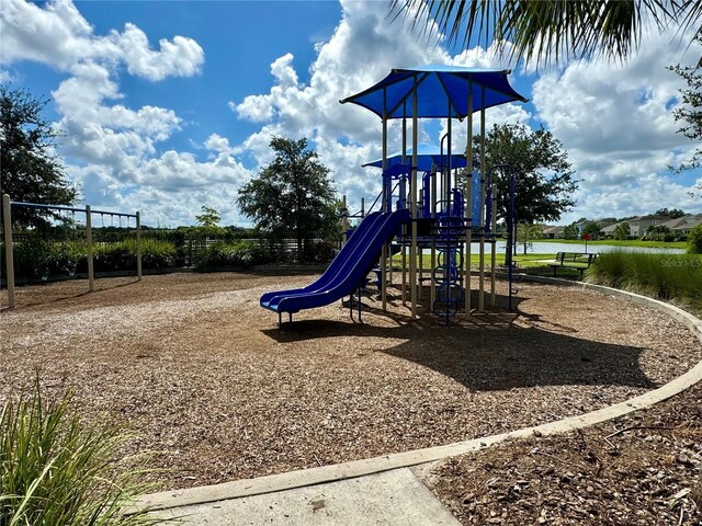 view of jungle gym with a water view