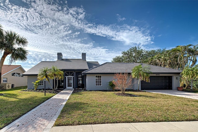 ranch-style house with a front lawn and a garage