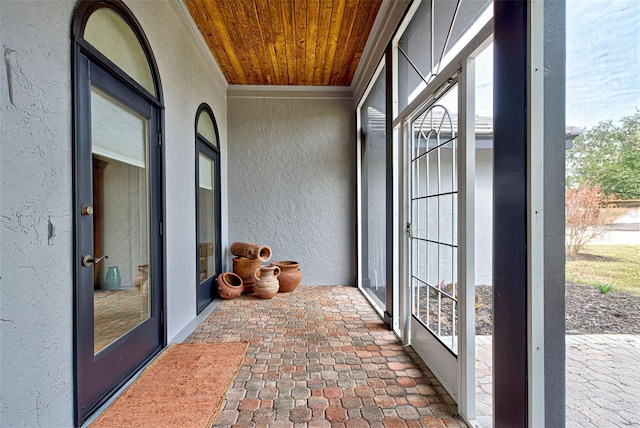 sunroom / solarium with a wealth of natural light and wood ceiling