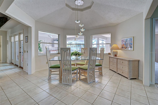 dining area with light tile patterned floors, a textured ceiling, and an inviting chandelier