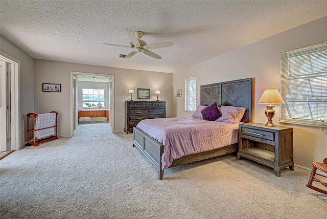 carpeted bedroom with ceiling fan and a textured ceiling