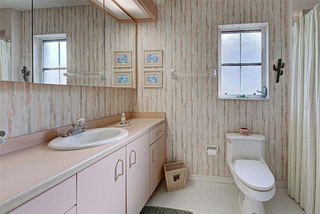 bathroom with tile patterned flooring, vanity, and toilet