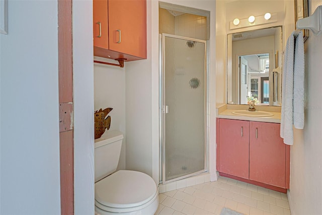 bathroom with tile patterned flooring, a shower with door, vanity, and toilet