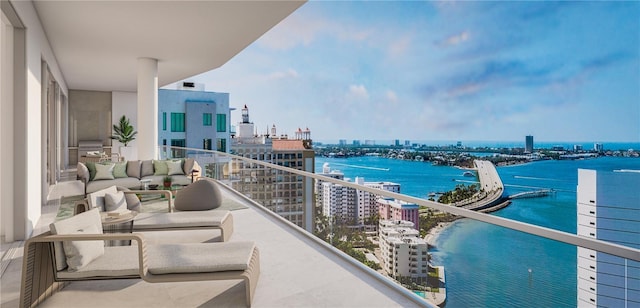 balcony with an outdoor hangout area and a water view