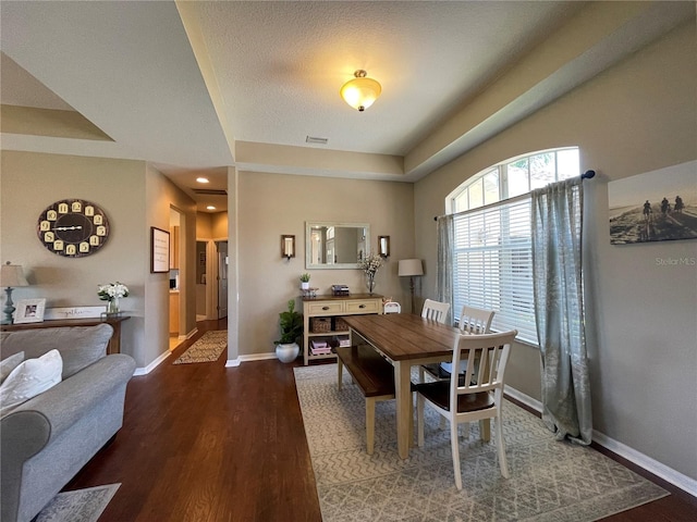 dining area with dark hardwood / wood-style flooring