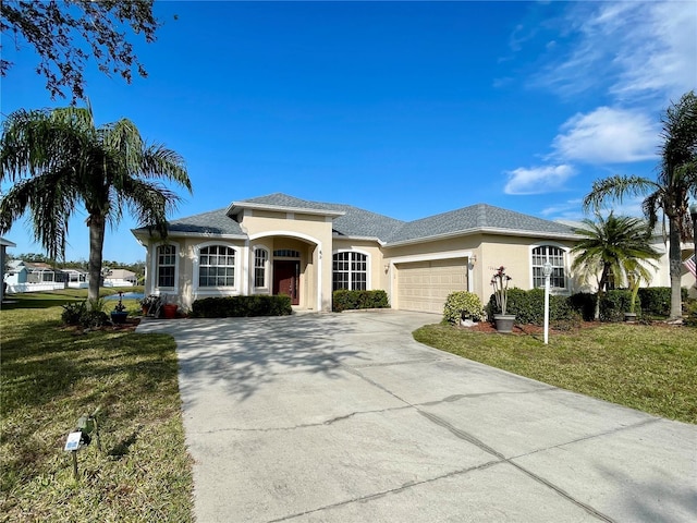 view of front of house featuring a garage and a front lawn