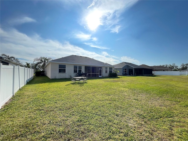 back of property featuring a lawn