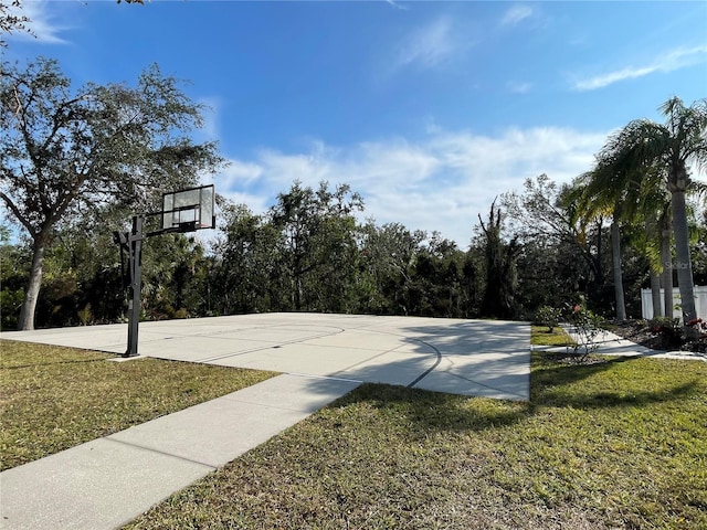 view of sport court featuring a yard