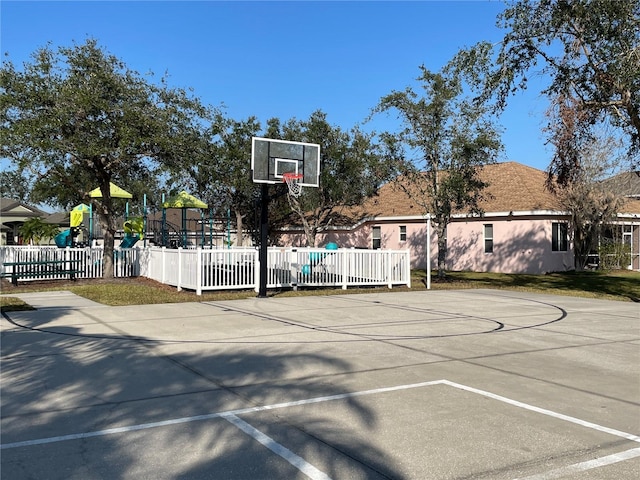 view of sport court featuring a playground