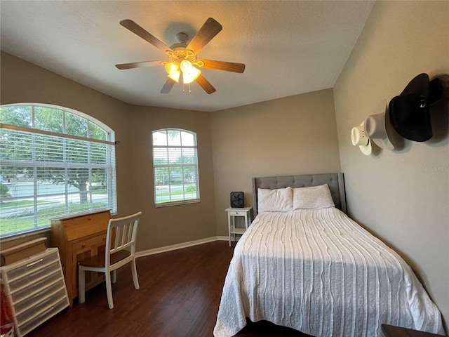 bedroom featuring ceiling fan and dark wood-type flooring