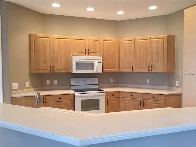 kitchen with white appliances and light brown cabinets