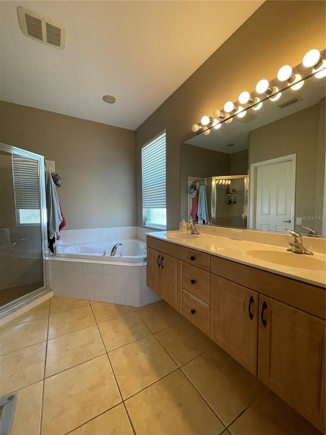 bathroom with plus walk in shower, tile patterned floors, and vanity