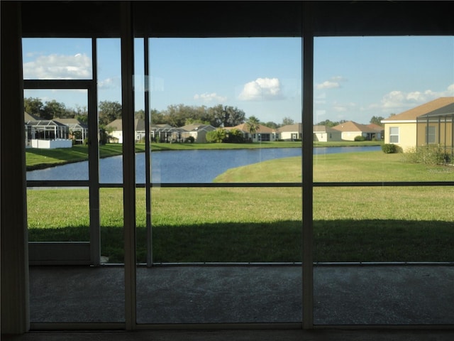 doorway with a water view and a wealth of natural light