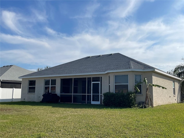 rear view of house featuring a yard