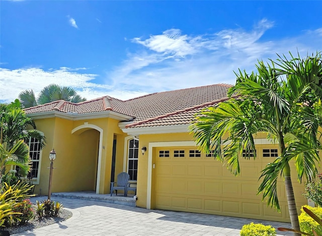 mediterranean / spanish-style home with a garage