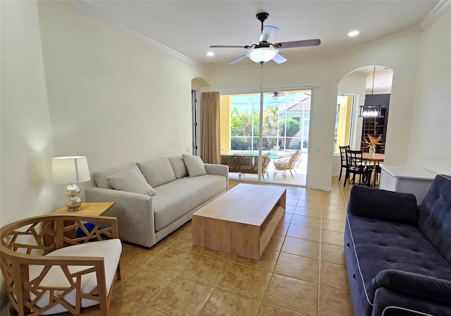 tiled living room with crown molding and ceiling fan with notable chandelier