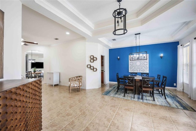 tiled dining room featuring crown molding, a tray ceiling, and ceiling fan with notable chandelier