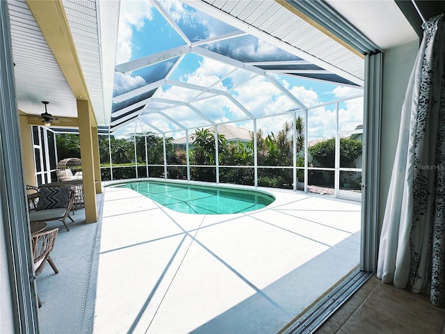 view of swimming pool with a lanai and a patio area