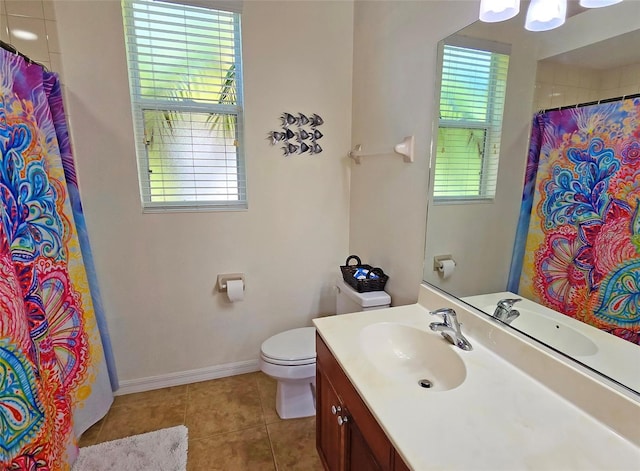 bathroom featuring a healthy amount of sunlight, tile patterned flooring, and vanity