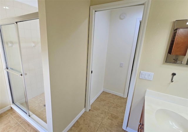 bathroom with walk in shower, tile patterned floors, and vanity