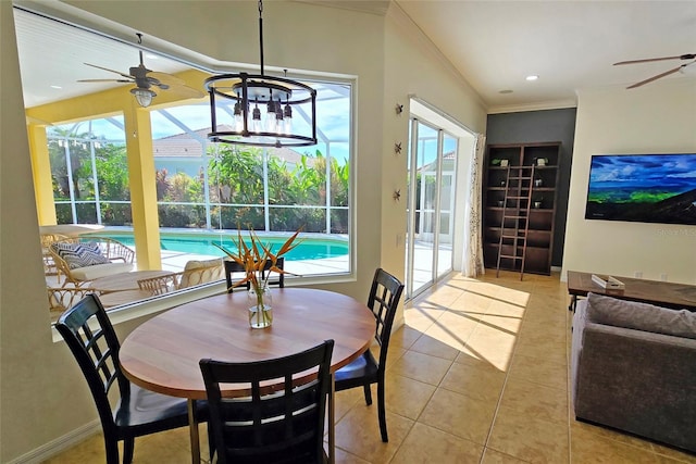 tiled dining area with crown molding, built in features, and ceiling fan