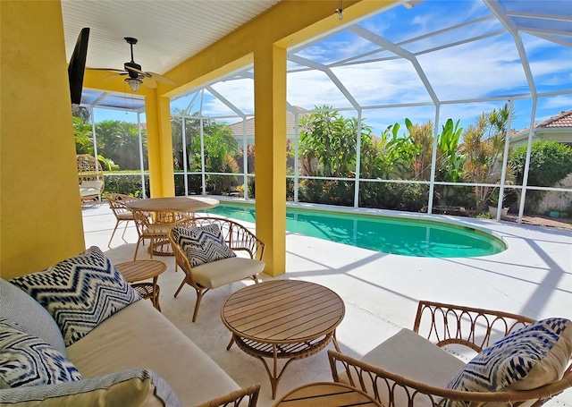 view of swimming pool with a lanai, ceiling fan, and a patio area