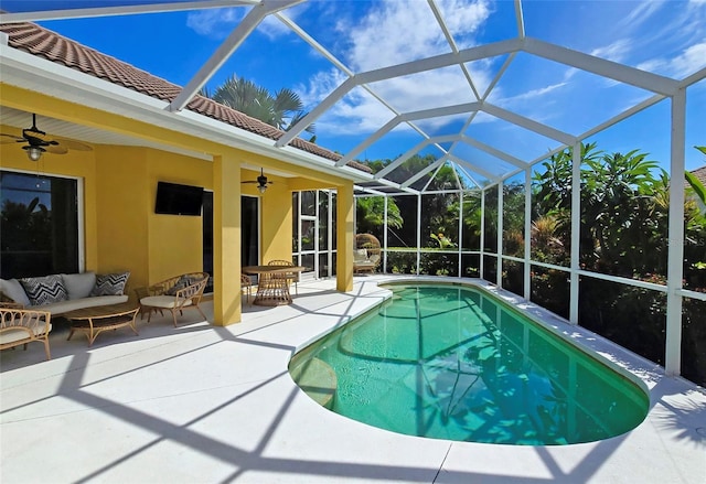 view of pool featuring glass enclosure and a patio