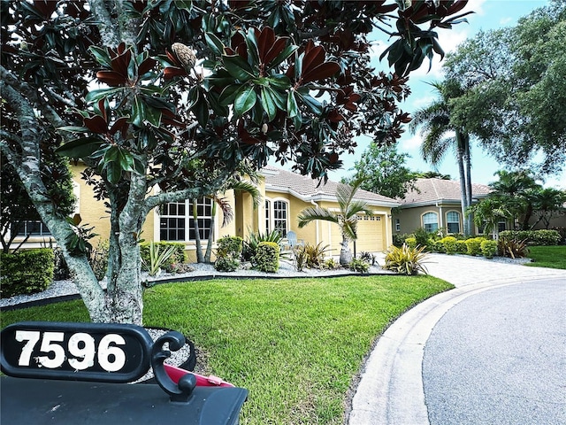 view of front of home with a garage and a front yard